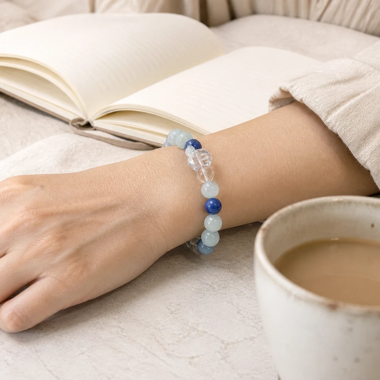 Calm Ritual Bracelet worn beside a notebook and morning cup