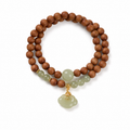 Brown wood bead bracelet with pale green ruyi focal detail