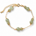 Pale green bead bracelet with gold-tone chain details