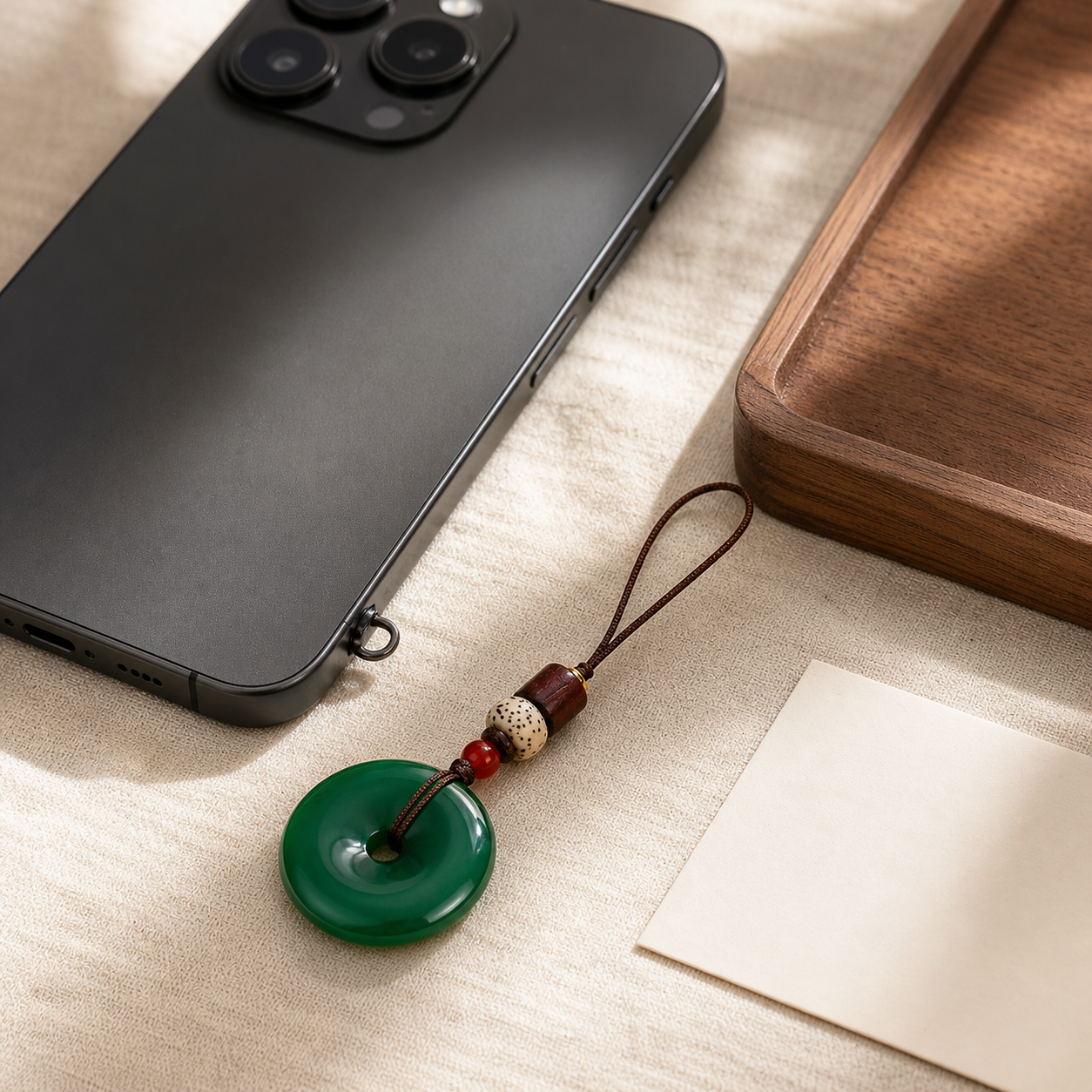 Green peace buckle charm attached to a black phone