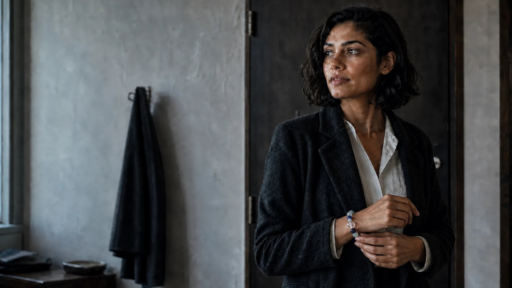 Woman touching her Calm Ritual Bracelet before leaving for the day